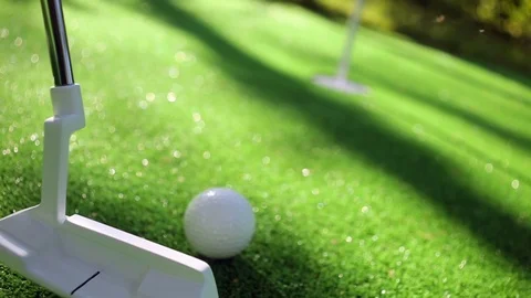 Close-up of golfer using putter to sink short putt into hole Stock Footage 78662992