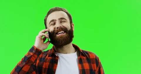 Close up of the good looking Caucasian man with a beard talking on the phone and Stock Footage 90377091