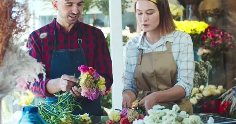 Close up of good-looking Caucasian man and woman florists working together in Stock Footage 138745022