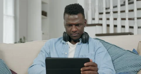 Close up of good-looking concentrated young confident black guy in casual Stock Footage 144349312