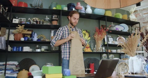 Close up of good-looking confident modern young bearded man which ties his work Stock Footage 143974260