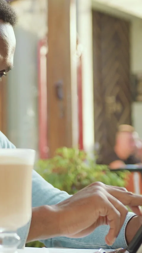 Close up of good-looking modern 30-aged bearded concentrated african american wh Stock Footage 325401401