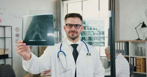 Close up of good-looking smiling experienced confident bearded 40-aged doctor in Stock Footage 160437421