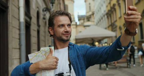 Close up of the good looking young man tourist on the city street taking selfie Stock Footage 139504416