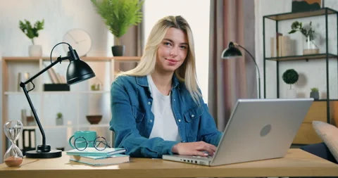 Close up of good-natured smiling pretty young woman in jeans shirt which sitting Stock Footage 158450020