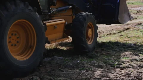 Close-up the grader wheels are driving on the ground Stock Footage 163145079