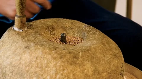 Close-up of the grain grinding process using an antique hand mill with ston.. Stock Footage 328830791