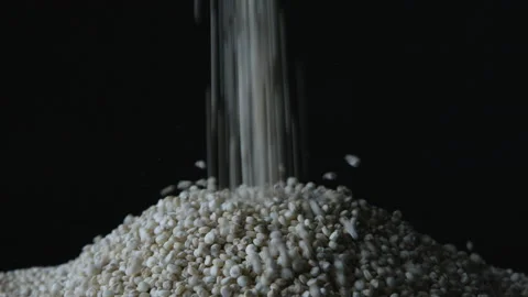Close-up on grains piling up against dark backdrop Stock Footage 146993531