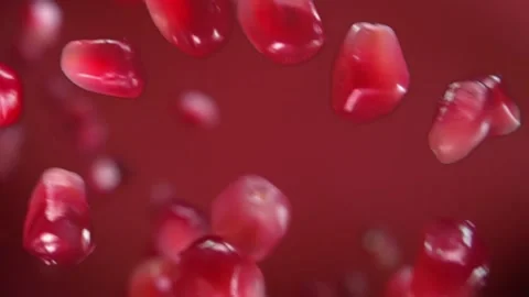 Close-up of grains of ripe pomegranate bouncing on the ruby red background 스톡 동영상 144176431