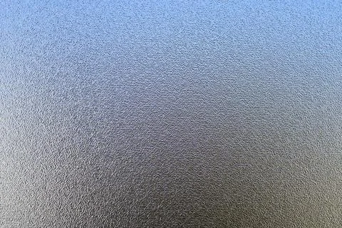 Close-up of grainy translucent surface with blue gradient. 写真素材