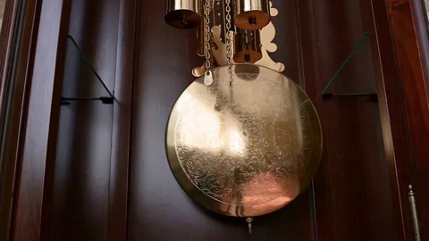 Close up of a grandfather clock pendulum moving Stock Footage 128517922