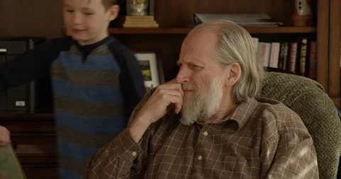 Close up grandpa choosing wrong glasses to read - 4K Stock Footage 89822768