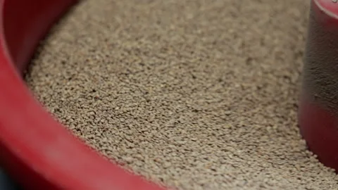 Close-up of granular abrasive media moving inside industrial processing Stock Footage 346611121