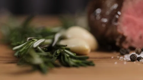 Close-up granules of salt and pepper garlic and rosemary on the background of Stock Footage 106933478