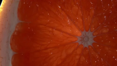 A close-up of grapefruit. Black background. Exotic fruit. Vidéo 147133208
