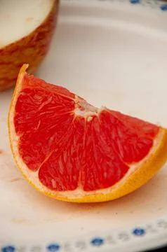 A Close-up of a Grapefruit Slice on a White Plate Stock Photos