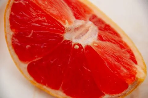 A Close-up of a Grapefruit Slice on a White Plate Stock Photos