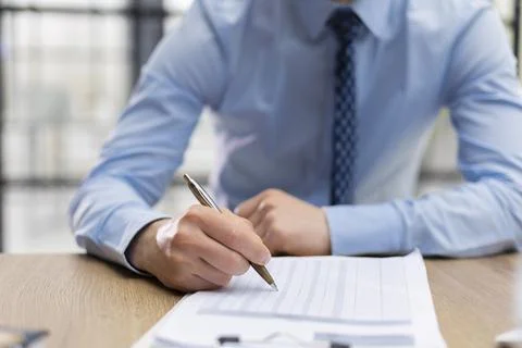 Close-up of graphs and charts analyzed by businessman. Stock Photos