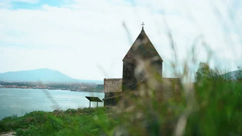 Close up grass and Old ancient Monastery on background. Summertime windy day Stock-Footage 195290599