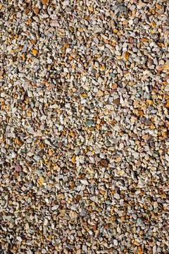 Close-up of a gravel surface with small, angular stones scattered throughout 스톡 사진