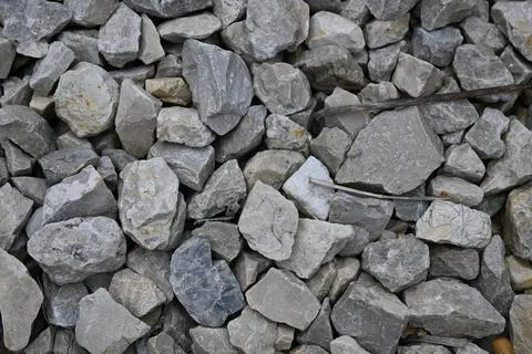 Close-up of gray angular rocks with metal wire Stock Photos