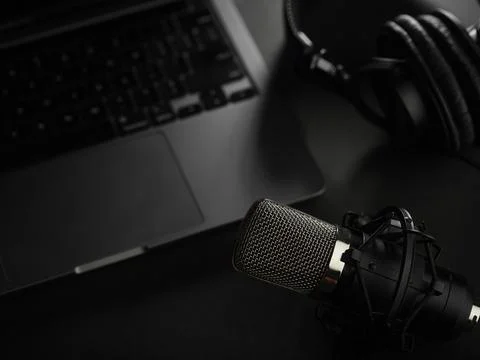 Close-up. On a gray background, a studio microphone, studio headphones on a l Stock Photos