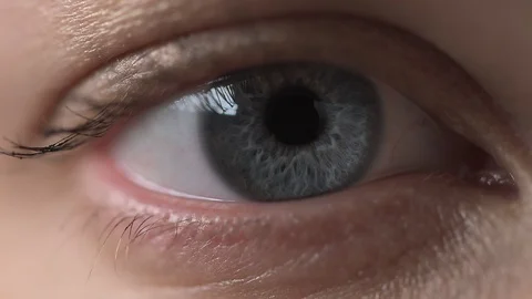 Close - up of the gray - blue eyes of a young woman. Selective focus Stock Footage