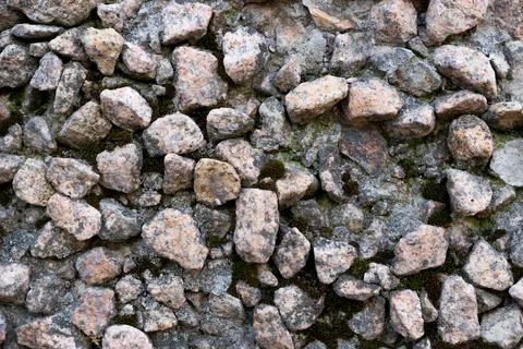 Close-up - gray-brown stone wall in the old facade of the house Stock Photos