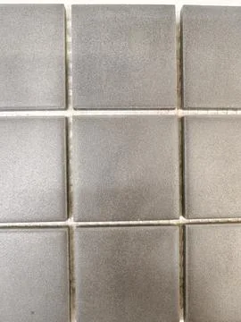 Close-up of gray ceramic wall tiles with grout lines 스톡 사진