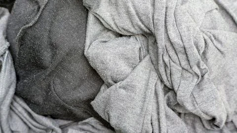 Close up of gray clothes in a hamper. Stock Photos