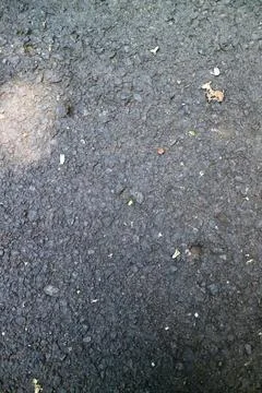 Close-up of gray concrete surface with small cracks and pebbles Stock-Fotos