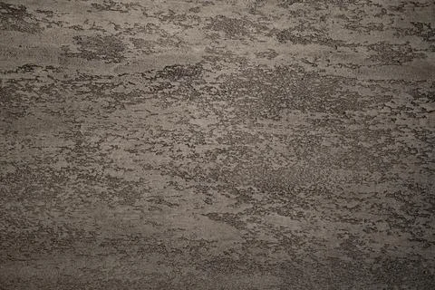 Close-up of gray concrete wall surface with small pits and irregular texture. Foto stock