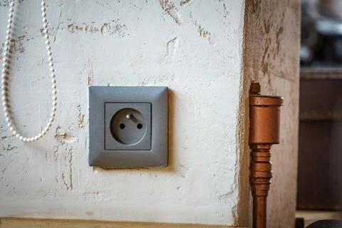 Close Up of a Gray Electrical Outlet on a White Wall Stock Photos