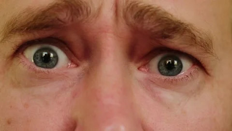 Close-up gray eyes of unhappy man. Stock Footage 274568898