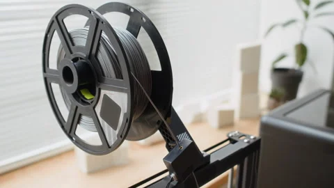 Close up of Gray Filament Mounted on 3D Printer Stock Footage 335690469