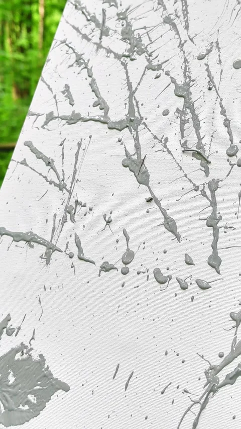 Close-Up of Gray Paint Splatters and Leaf Impressions on White Canvas Stock Footage 336614193