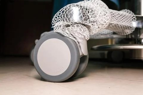 Close-up of gray roller skate wheel on tiled floor Stock Photos