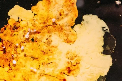 Close-up of grease and liquid mixture with bubbles and flowing patterns, ar.. 스톡 사진