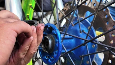 Close-up greasy hands assembling motorcycle front suspension fork Stock Footage 325769055