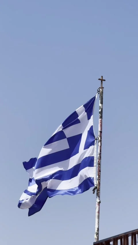 Close-up of the Greek flag waving in the wind during a bright summer day in Vídeos de archivo 345179108
