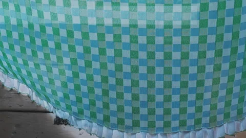 Close up of a green and blue checkered curtain with a white ruffle gently Stock-Footage 342278552