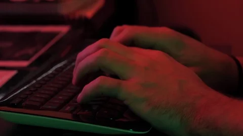 Close up of green and red light on man's hands typing Stock Footage 118977265