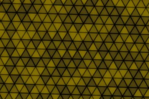 Close-up of green and yellow triangle pattern on fabric 스톡 일러스트