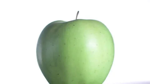 Close-up of a green apple on a white background Stock Footage 169933860