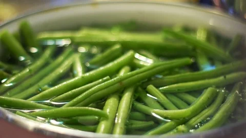 Close up of green beans cooking in slow boiling wather in slow motion Stock Footage 85066639