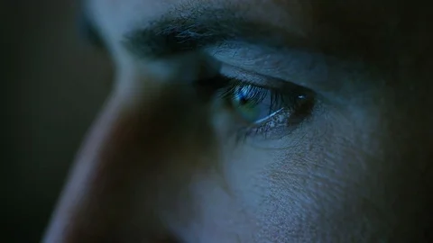 Close-up of a Green-Blue Man's Eyes with Screen Reflecting in Them Stock Footage