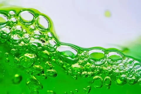 Close-up of green bubbles in a liquid with foam Stock Photos