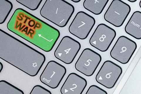 Close-up of a green button with the word Stop war on it. Concept of Stop the war Stock Photos
