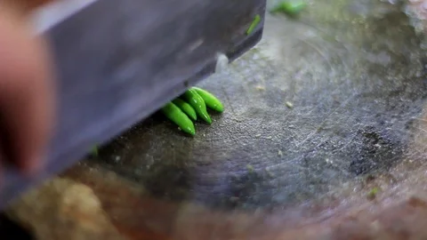 Close up of green chilli chopping on  kitchen Stock Footage 109682407