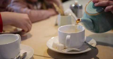 Close-up of green Chinese tea being poured into white cup Video stock 308451293